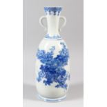 A 20th CENTURY JAPANESE BLUE AND WHITE PORCELAIN VASE, decorated with scenes of flora, 33cm high,