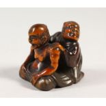A VERY UNUSUAL JAPANESE BOXWOOD & LACQUER NETSUKE, depicting the blind masseur, Meiji period, artist