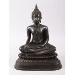 A GOOD EARLY TIBETIAN BRONZE FIGURE OF A BUDDHA, possibly Shakyamuni, sat upon a double lotus