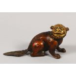 A CHINESE BRONZE OKIMONO OF A FOO DOG, sat in a resting pose with a smile, 20cm wide, 10.3cm high.