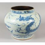 A CHINESE YUAN STYLE BLUE & WHITE PORCELAIN DRAGON JAR, the base unglazed, 32.5cm wide at widest