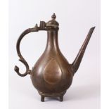 A PERSIAN ENGRAVED BRONZE EWER, 26cm high.