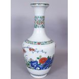 A CHINESE DOUCAI PORCELAIN VASE, the sides decorated with a garden scene of butterflies, flowers,