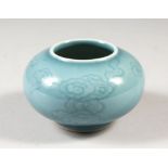A CHINESE PORCELAIN CELADON GLAZED WATER BOWL, with swirling clouds around the body of the bowl,
