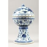 A CHINESE MING STYLE BLUE & WHITE COVERED PORCELAIN STEM BOWL, decorated with dragons and phoenix