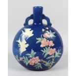 A CHINESE BLUE GROUND PORCELAIN MOONFLASK, incised polychrome decoration of birds amongst flowers,