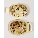 A CARVED AND PIERCED CHINESE JADE BUCKLE, with scenes of figures, 13.5cm wide, 4.9cm high.