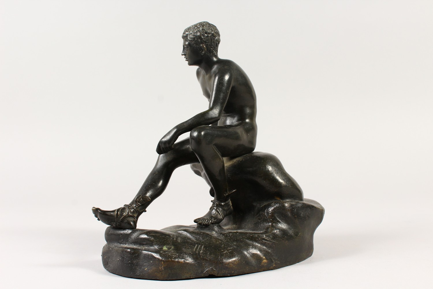AFTER THE ANTIQUE A BRONZE OF HERMES, sitting on a rock. 19cms high. - Image 4 of 10