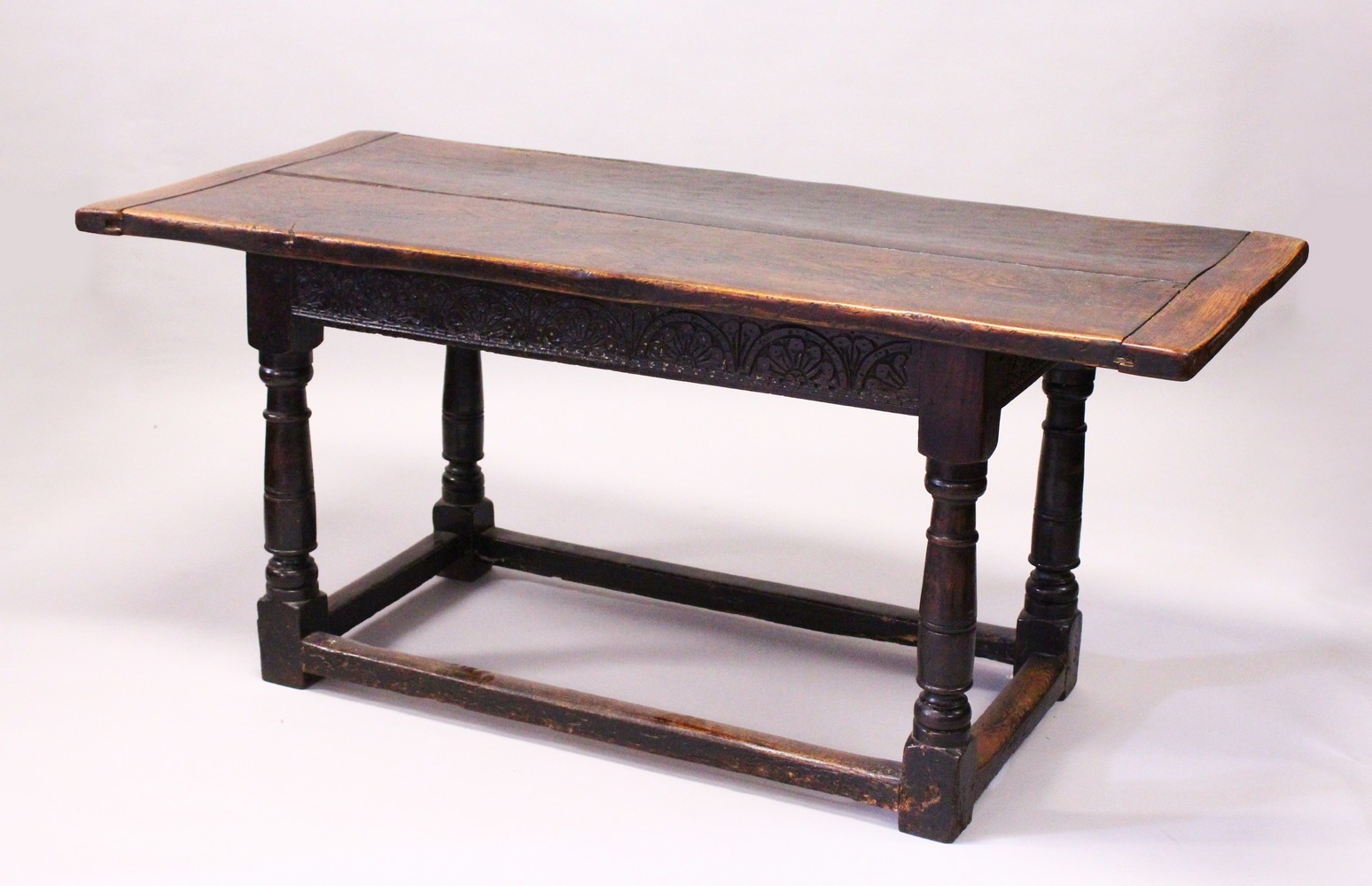 AN 18TH CENTURY OAK REFECTORY DINING TABLE, with a cleated twin plank top, on gun barrel turned legs