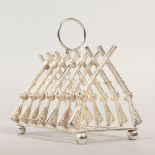 A NOVELTY TOAST RACK, modelled as crossed guns. 11cms long.