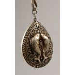 A CHINESE SILVER PIERCED PENDANT, decorated with fish. 6cms high.