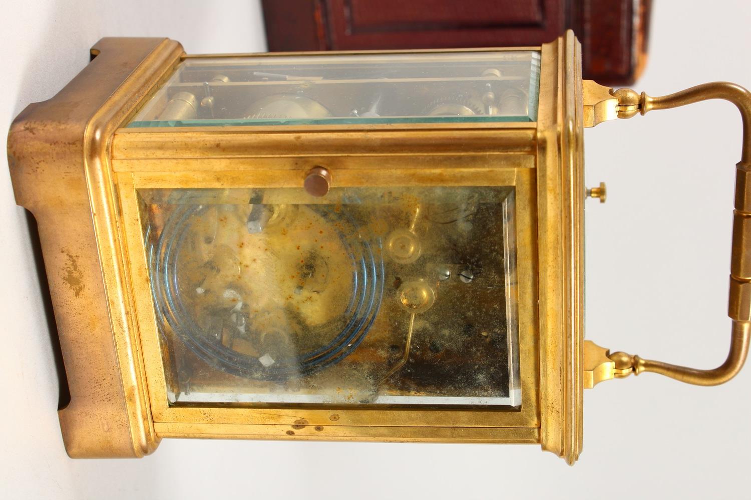A FRENCH BRASS CARRIAGE CLOCK, with repeat and alarm, striking on a gong, in a leather case. 14cms - Image 4 of 14