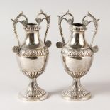 A PAIR OF CONTINENTAL SILVER TWO HANDLED VASES. 13cms high. Weight 12ozs.