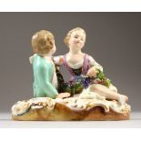 A GOOD SMALL 19TH CENTURY MEISSEN PORCELAIN GROUP OF A SEATED BOY AND GIRL, the girl with a
