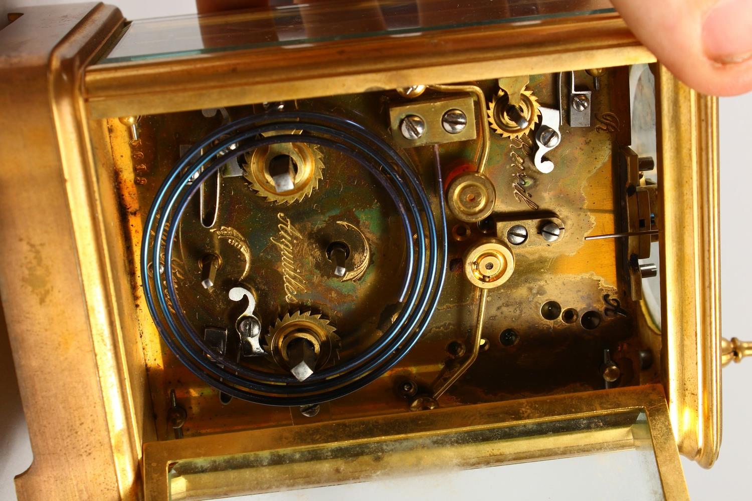 A FRENCH BRASS CARRIAGE CLOCK, with repeat and alarm, striking on a gong, in a leather case. 14cms - Image 5 of 14
