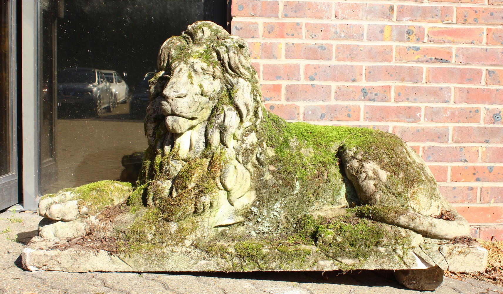 AN IMPOSING PAIR OF RECONSTITUTED STONE LIONS, in a recumbent pose, each looking to the side. 128cms - Image 2 of 10