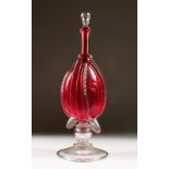 A VICTORIAN RUBY GLASS BELLOWS SHAPED DECANTER AND STOPPER. 36cms high.