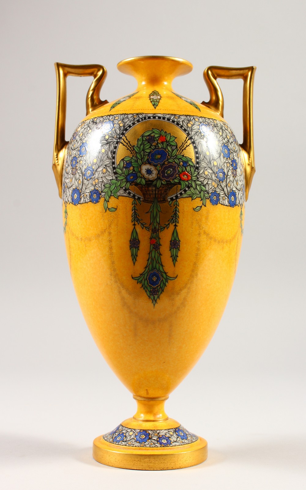 A ROYAL WORCESTER TWO-HANDLED VASE, with yellow ground painted with flowers and garlands. 28cms