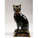 AN EARLY 19TH CENTURY ENGLISH POTTERY BLACK FIGURE OF A SEATED CAT, CIRCA. 1830, on a gilt decorated