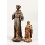 A 17TH CENTURY CARVED WOOD SAINT, and ANOTHER holding the Christ child (2). 30cms x 15cms high, Both