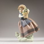 A LLADRO FIGURE, YOUNG GIRL holding a plant in a pot. 17cms high.