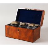 A GOOD GEORGE III MAHOGANY CASED TEA CADDY fitted with three cut glass oval bottles with silver