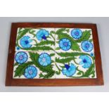 A FRAMED SET OF FOUR WILLIAM DE MORGAN TILES, painted in polychrome and decorated with blue