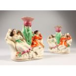 A PAIR OF STAFFORDSHIRE VASE GROUPS, two girls sleeping. 15cms high.