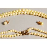 A DOUBLE ROW PEARL NECKLACE with gold clasp.