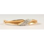 A YELLOW GOLD DIAMOND BANGLE.