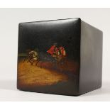 A RUSSIAN SQUARE PAPIER MACHE BOX, the top painted with a sleigh being pulled by three horses. 11cms
