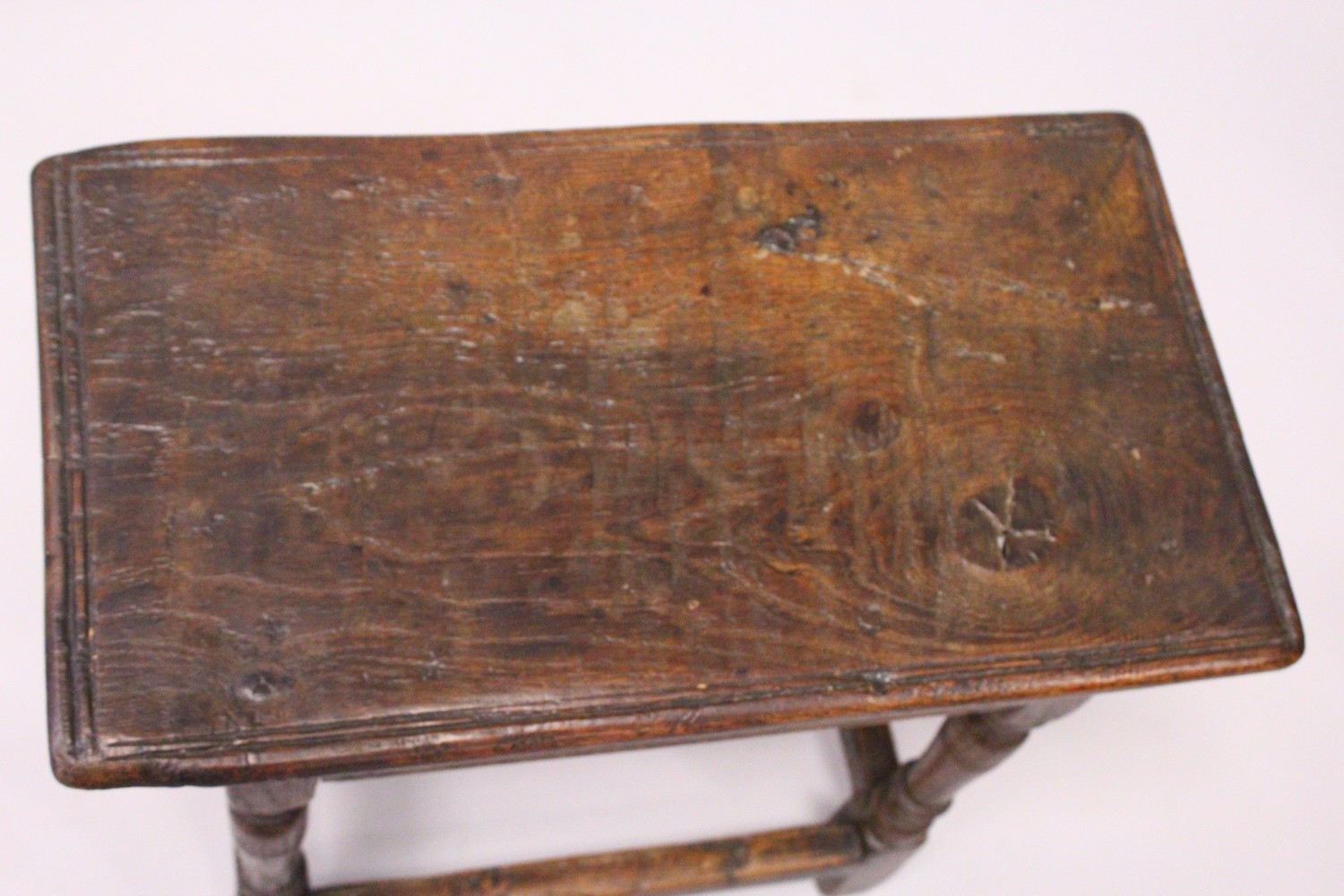 AN 18TH CENTURY OAK JOINT STOOL, with moulded top, carved frieze on turned legs united by - Image 3 of 4