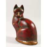 AN ISLAMIC CARVED SEATED CAT with brass nose, collar and bone. 21cms high.