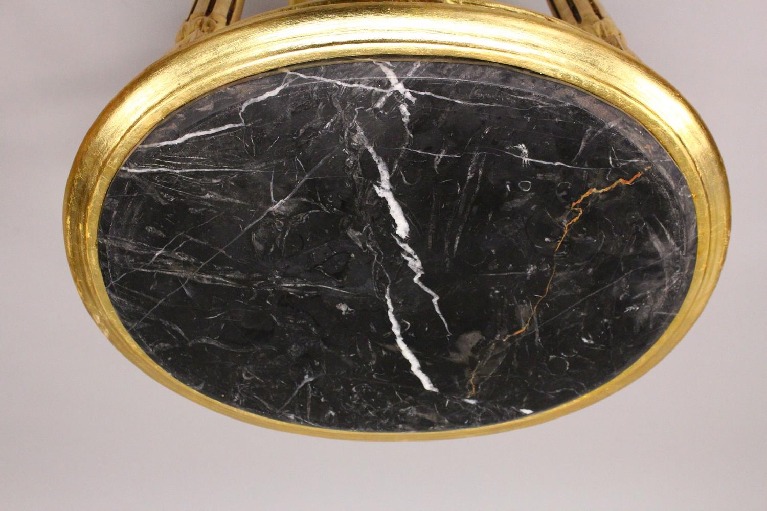 A FRENCH STYLE GILTWOOD OVAL TABLE, inset with a black marble top. 50cms wide x 72cms high. - Image 2 of 2