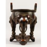 A LARGE CHINESE BRONZE TWIN-HANDLED CIRCULAR CENSER, supported on three elephant head legs, with a