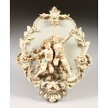 A CONTINENTAL PORCELAIN PLAQUE, with two cupids in relief. 29cms long.