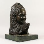 AN ABSTRACT BRONZE, bust of a man praying, on a marble base. 40cms high.