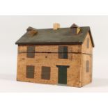 A PAINTED WOOD BOX, in the form of a house. 26cms high.