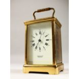 MARTIN & CO., CHELTENHAM, an English brass carriage timepiece, white dial with black Roman numerals.