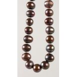 A STRING OF BLACK TAHITI PEARLS.