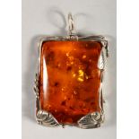 A SILVER AND AMBER PENDANT.