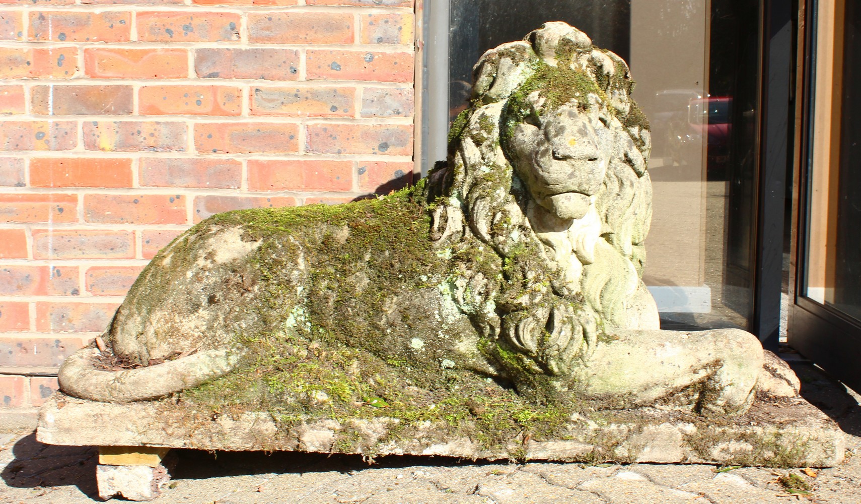 AN IMPOSING PAIR OF RECONSTITUTED STONE LIONS, in a recumbent pose, each looking to the side. 128cms - Image 10 of 10