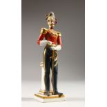 A MINIATURE PORCELAIN NAPOLEONIC GUARDSMAN. 17cms high.