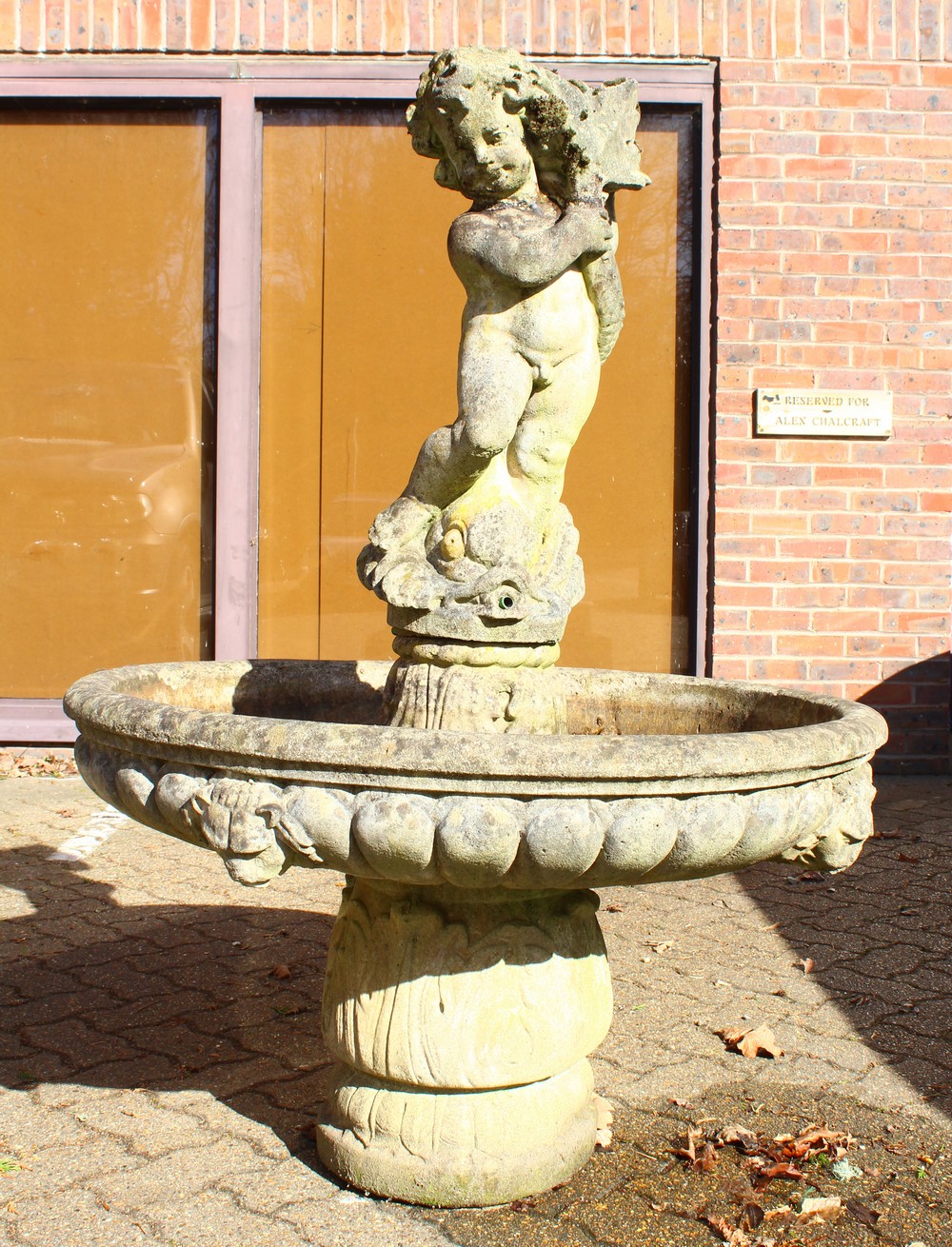 A LARGE CLASSICAL STYLE RECONSTITUTED STONE GARDEN FOUNTAIN, with a standing cherub, circular bowl
