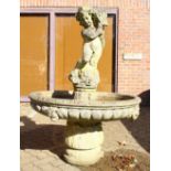 A LARGE CLASSICAL STYLE RECONSTITUTED STONE GARDEN FOUNTAIN, with a standing cherub, circular bowl