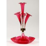 A VICTORIAN RUBY GLASS CENTREPIECE with four trumpets. 36cms high.