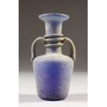 A ROMAN BLUE TWO-HANDLED GLASS VASE. 12cms high.