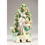 AN 18TH CENTURY DERBY BOCAGE GROUP, classical lady and cupid on a scrolled base. 20cms high.