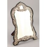 AN UPRIGHT SILVER PHOTOGRAPH FRAME on a velvet frame. 29cms high.