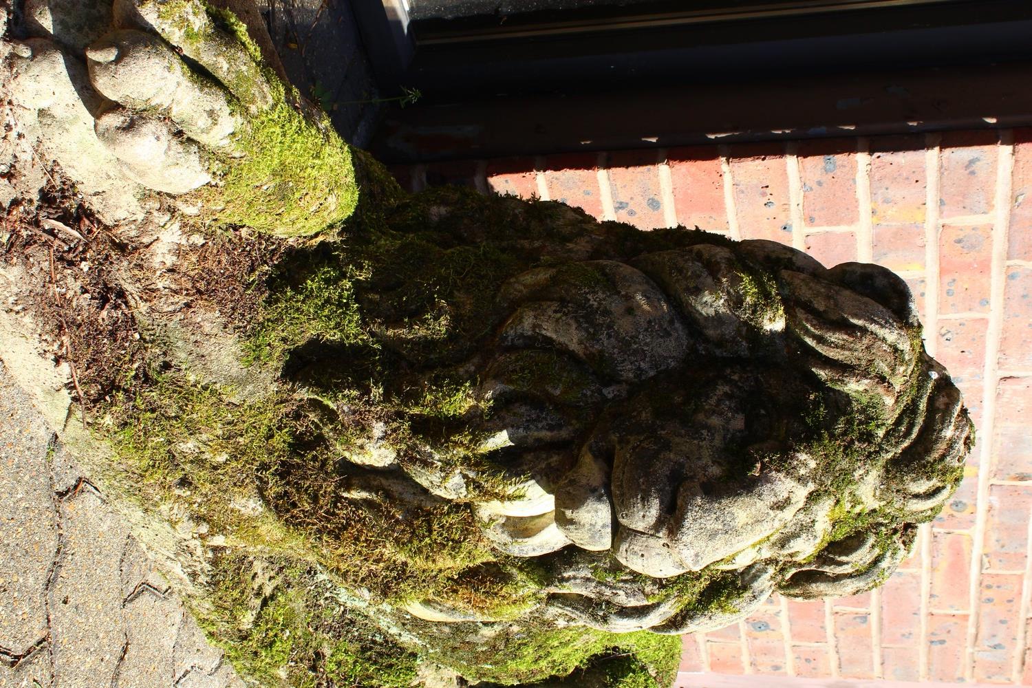 AN IMPOSING PAIR OF RECONSTITUTED STONE LIONS, in a recumbent pose, each looking to the side. 128cms - Image 9 of 10